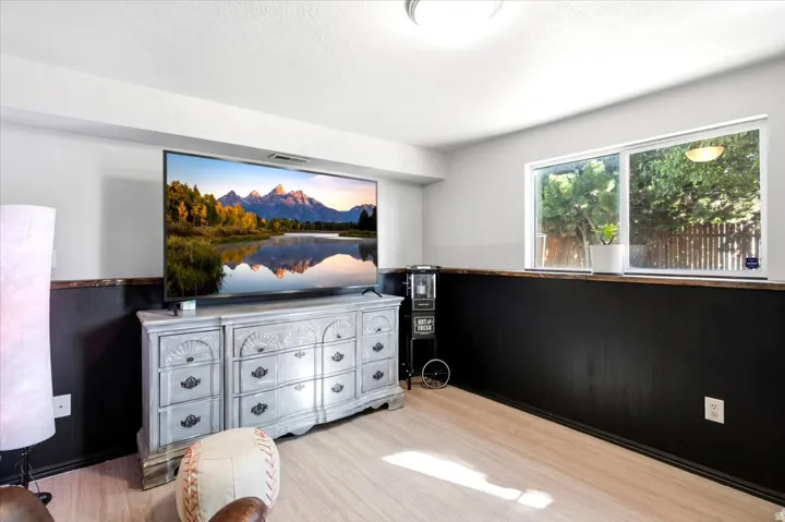 Light wood-finish flooring, two-tone wall treatment, and a double-pane window
