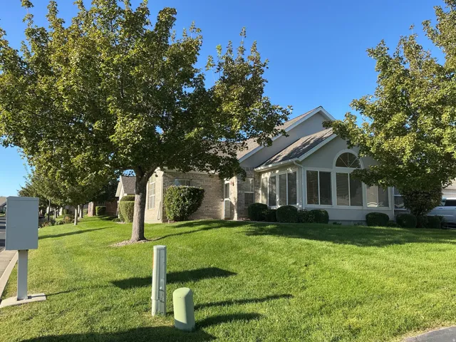 Brick and siding exterior with mature landscaping