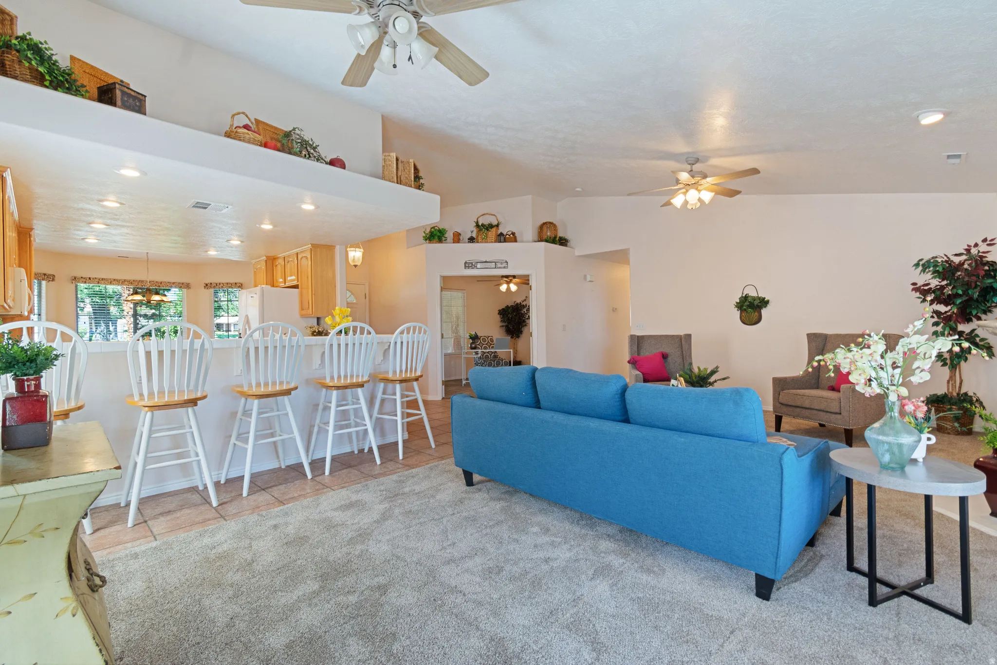 Vaulted ceilings, overhead recessed lighting, and ceiling fans