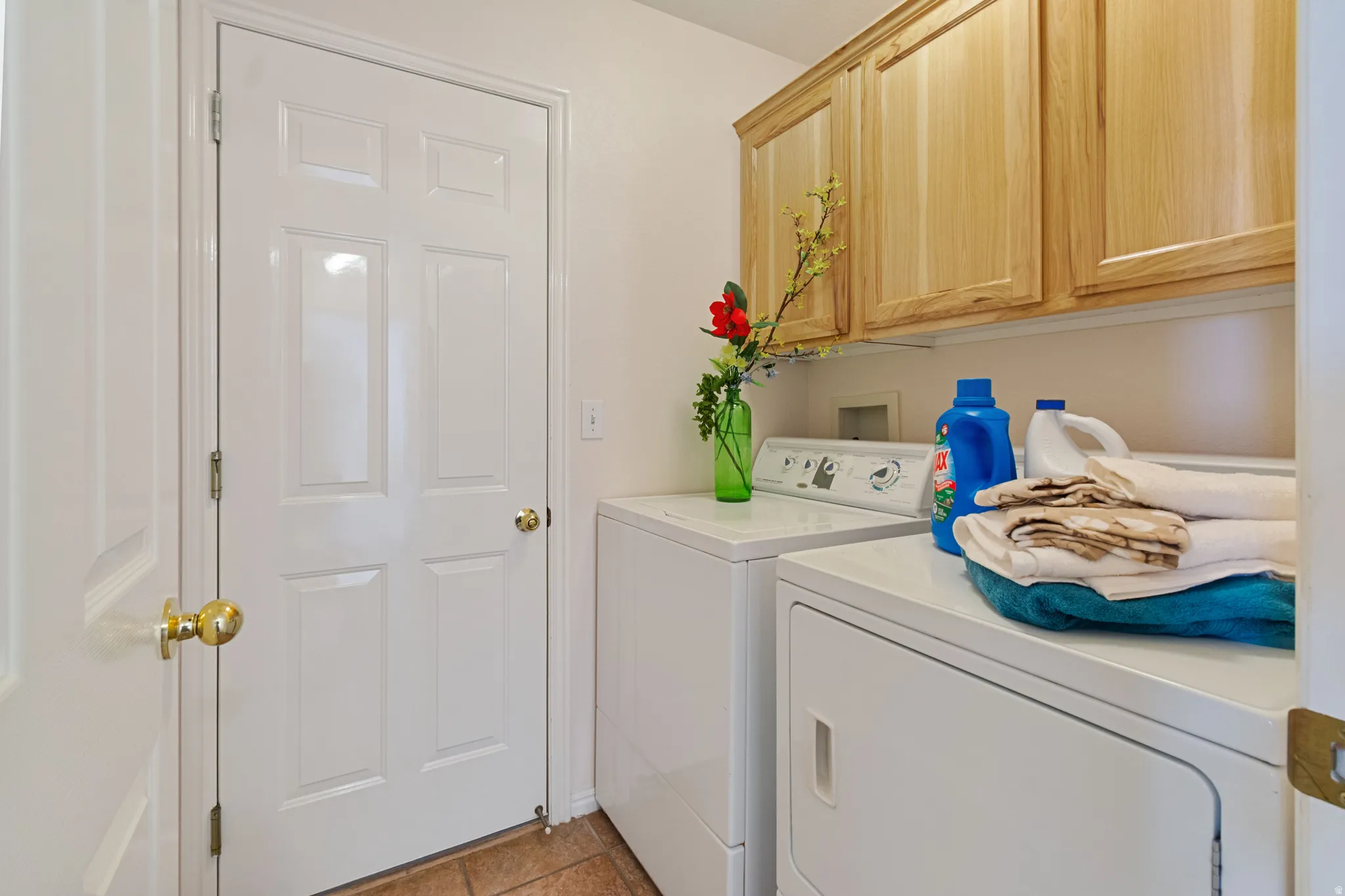 Natural wood-finish cabinetry provides storage above appliances