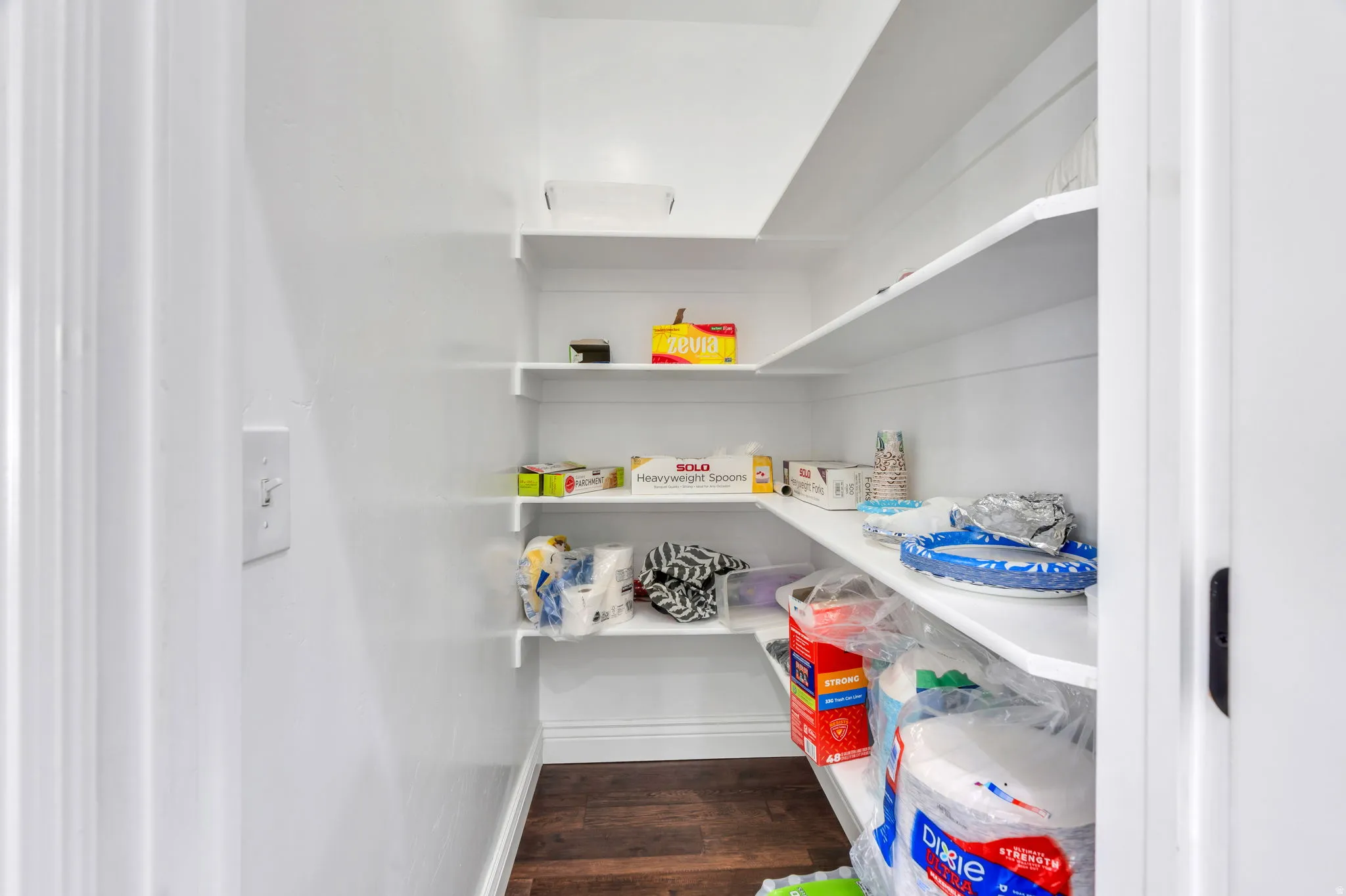Built-in shelving with white finishes and wood-finish flooring