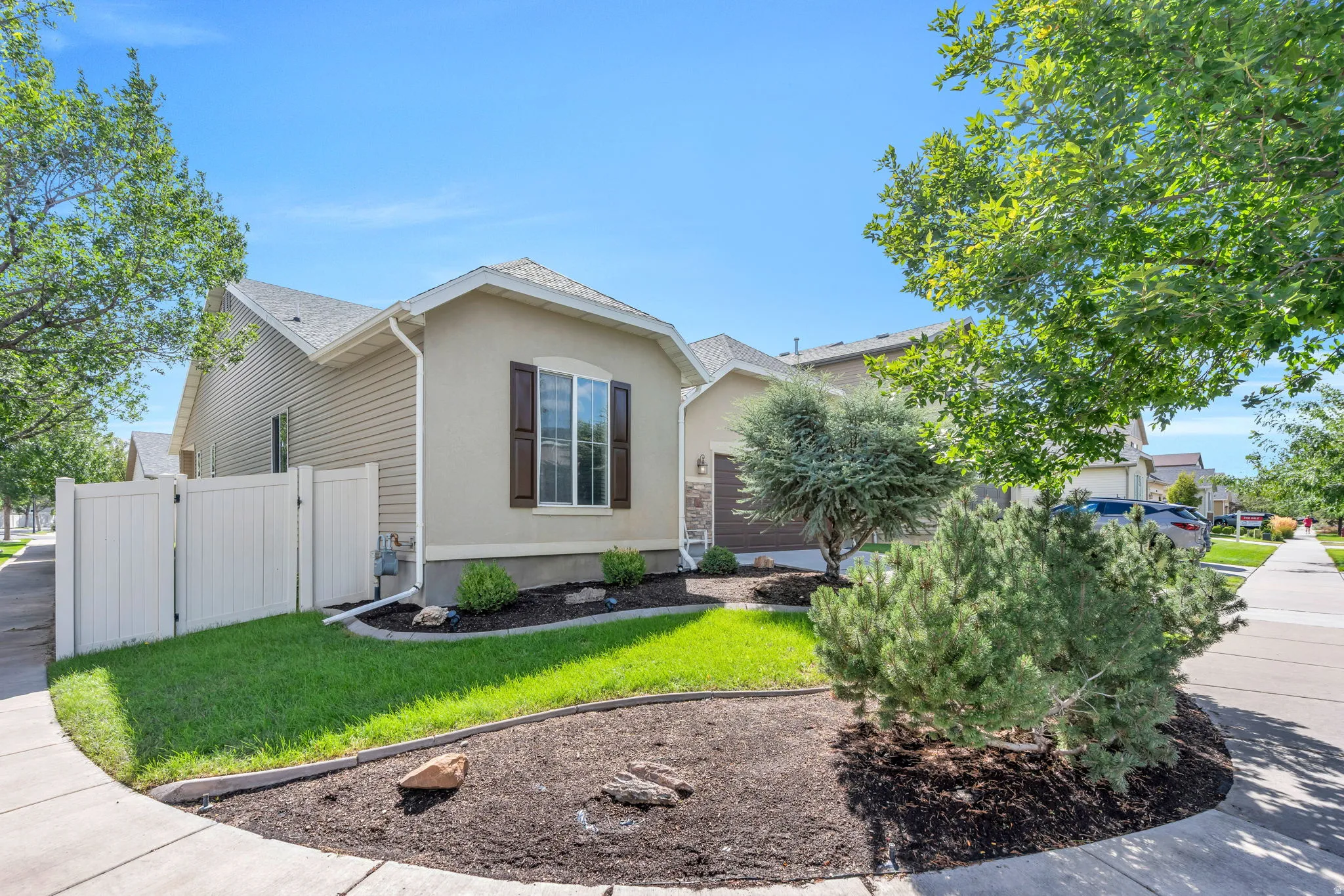 Stucco and siding exterior with dark shutters