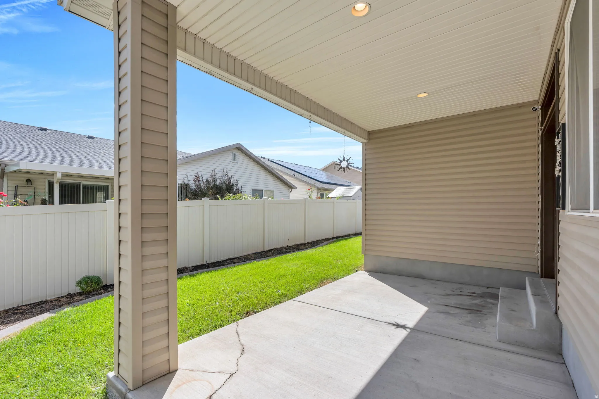 Covered concrete patio with recessed lighting and siding exterior