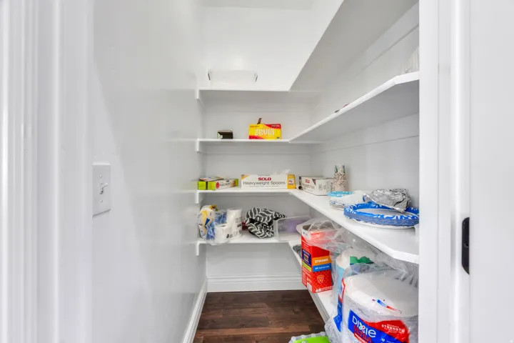 Built-in shelving with white finishes and wood-finish flooring