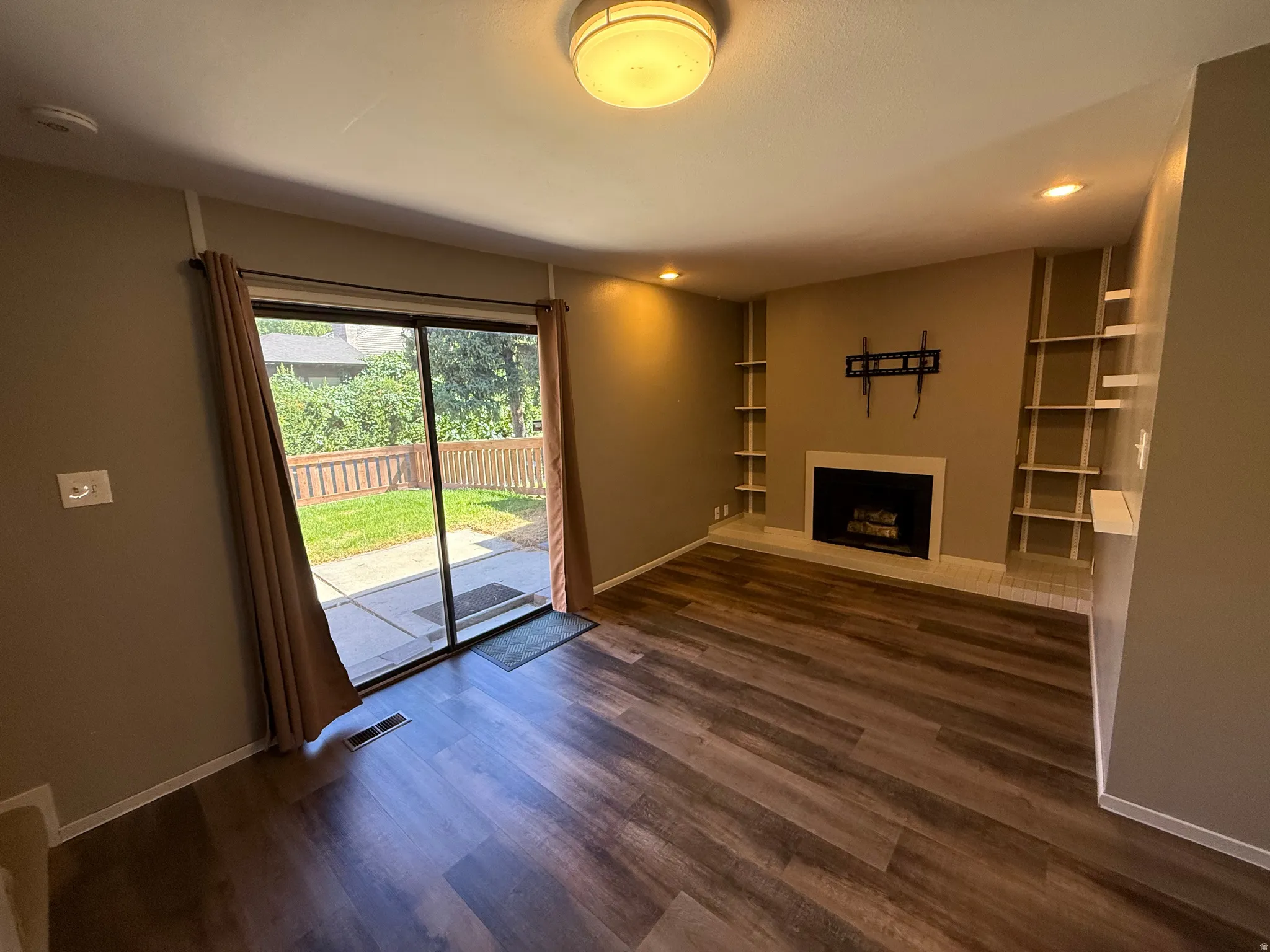 Wood-finish flooring throughout, complemented by recessed lighting and a ceiling-mounted fixture