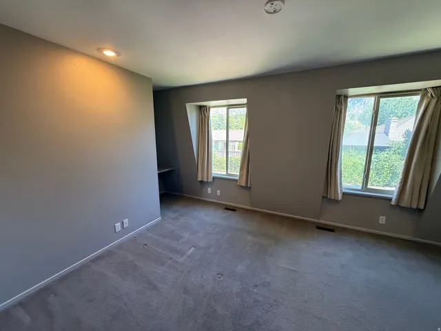 Wall-to-wall carpeting, recessed lighting, and three large windows