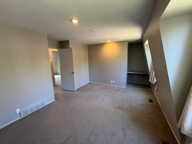 Recessed lighting, built-in shelving, hard surface countertop.