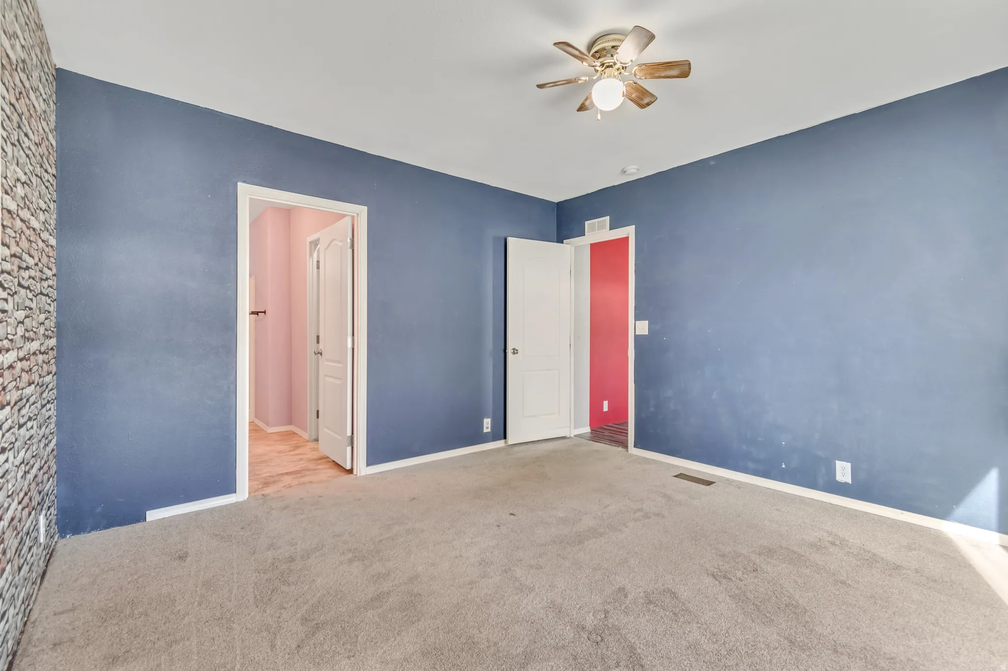 Carpeted flooring, ceiling fan with light fixture, and blue painted walls