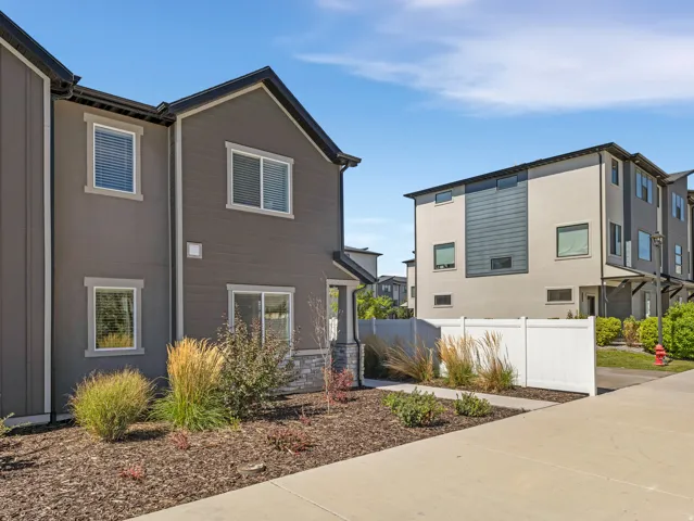 Contemporary exterior with varied siding textures and stone accents