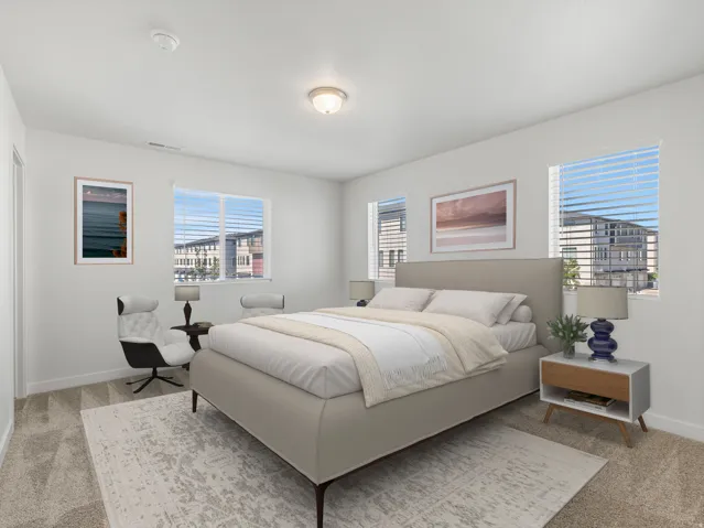 Bright room featuring multiple windows with blinds, carpeted flooring, and a flush-mount ceiling light fixture