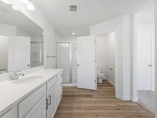 Double vanity with white cabinetry and integrated sink