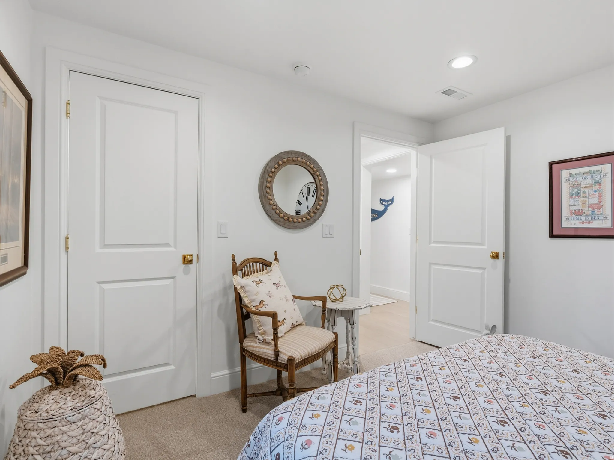 White interior doors, recessed lighting, and light-colored wall-to-wall carpeting