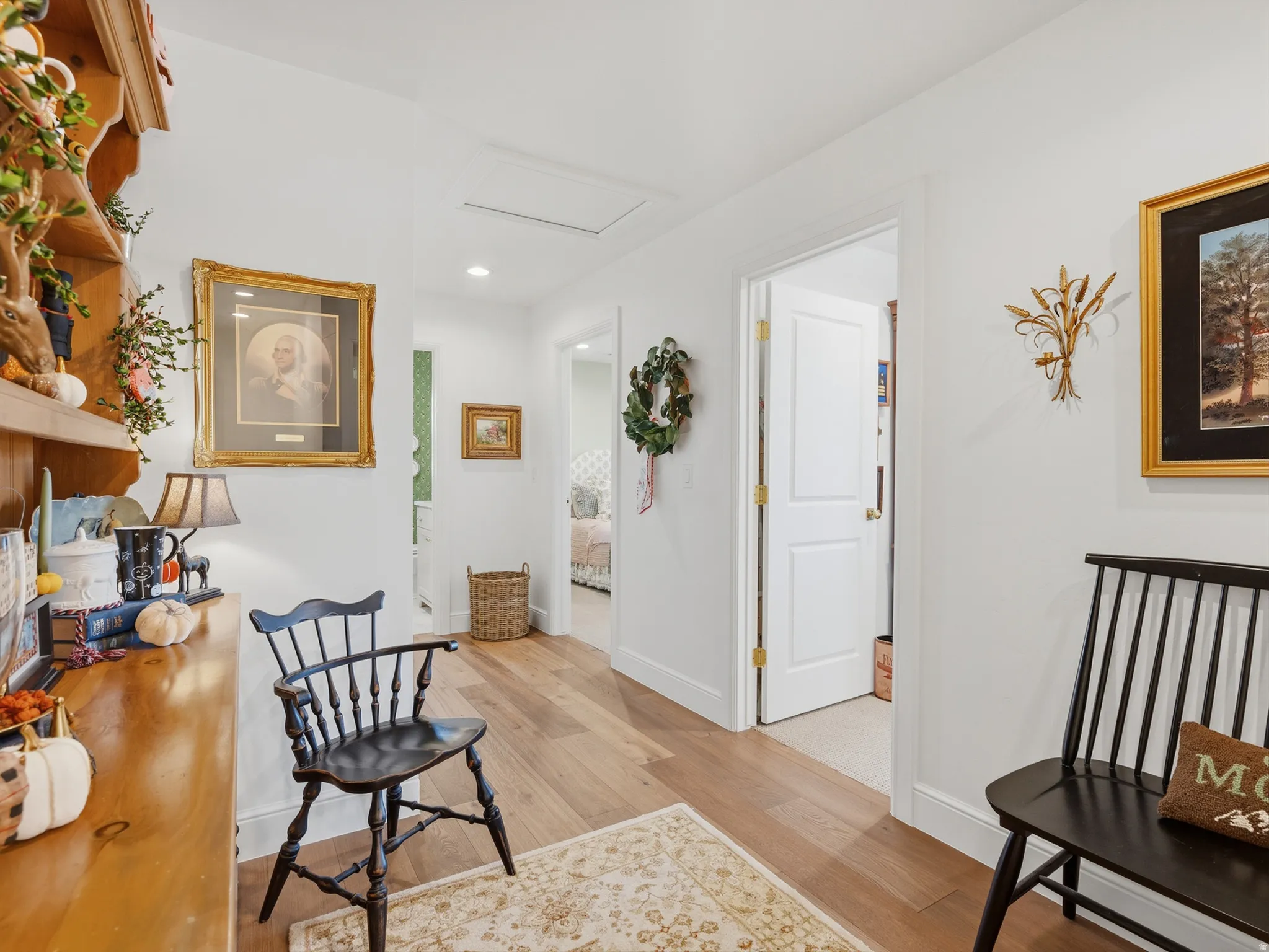 Hallway featuring wood-finish flooring, recessed lighting, and white paneled doors