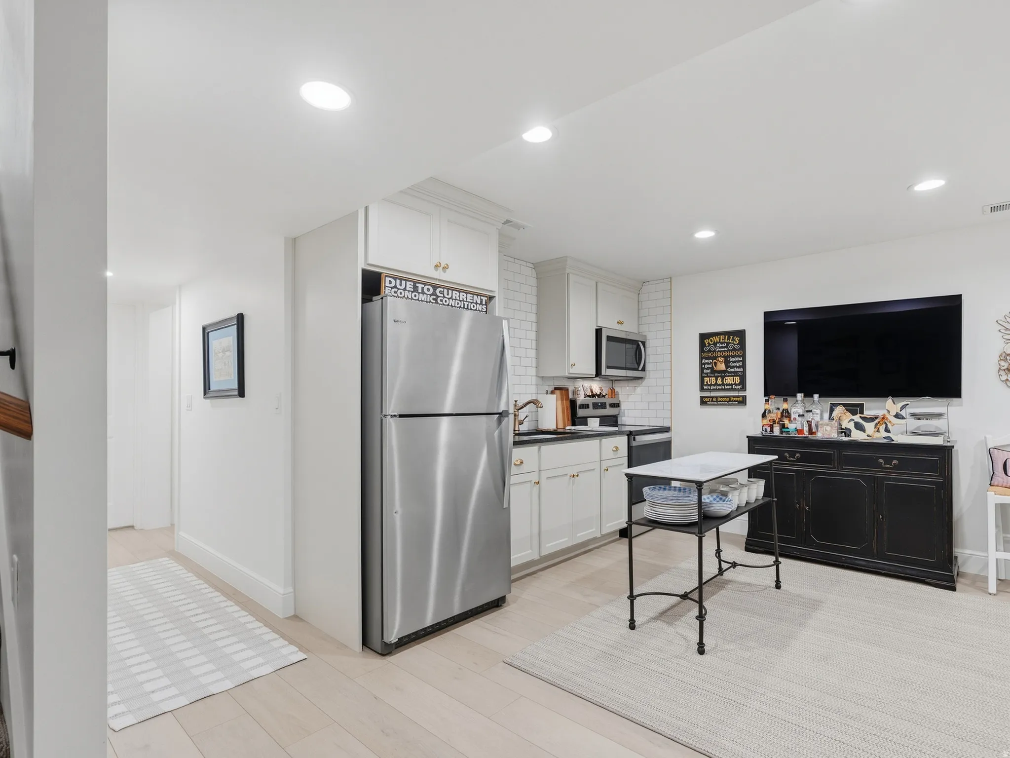 Kitchenette with white subway tile backsplash, stainless steel appliances, and recessed lighting