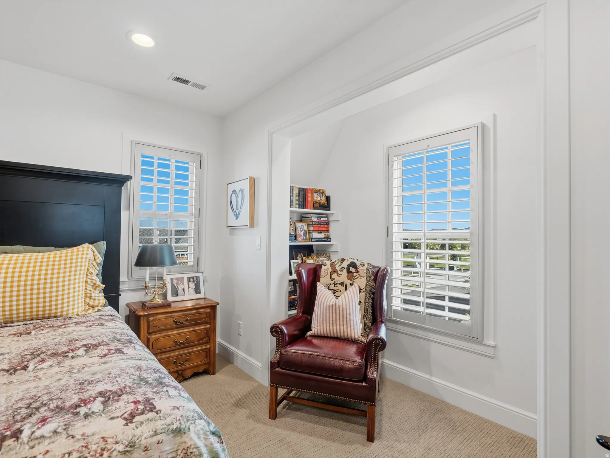 Recessed lighting, built-in shelving, window with plantation shutters, paneled walls, and carpeted flooring