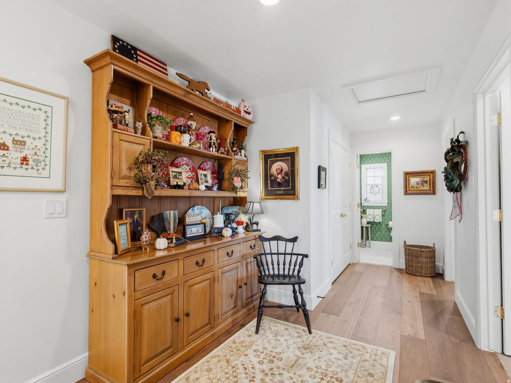 Wood-finish flooring throughout, bright white walls, recessed lighting, and a clearly defined doorway