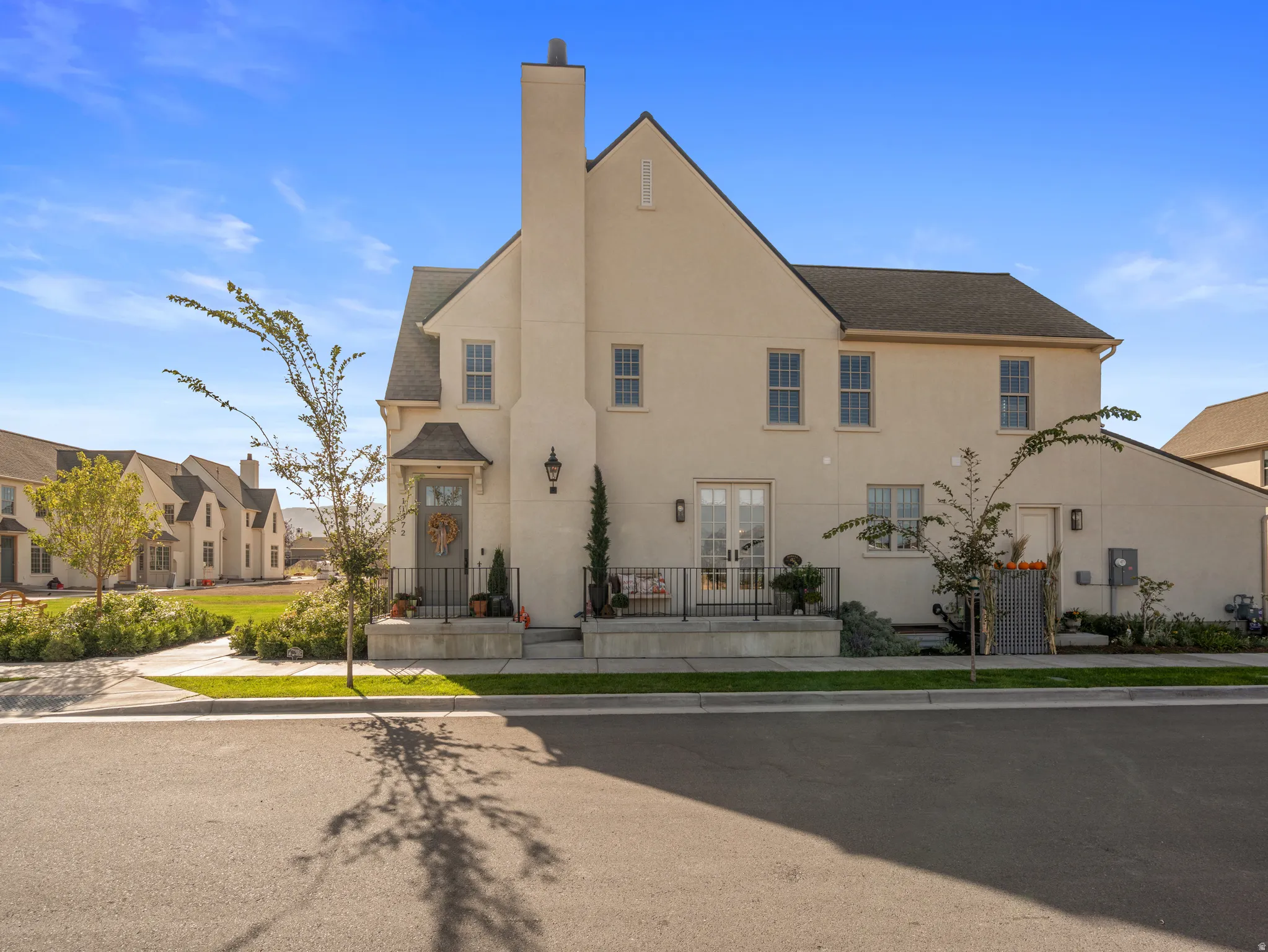 Stucco exterior with a prominent chimney and multiple windows