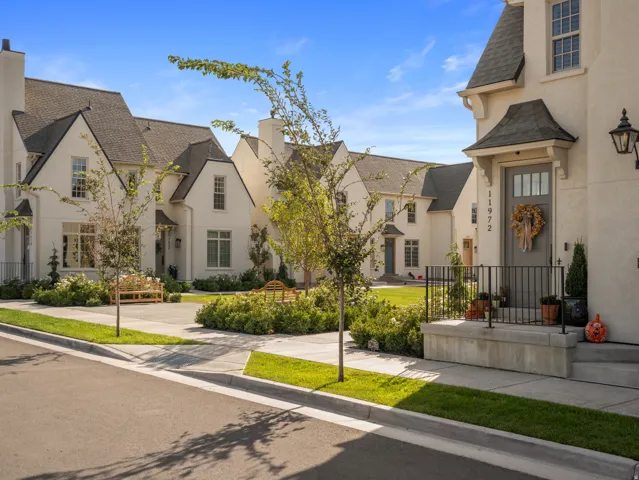 Stucco exterior with gabled roofs and dark trim