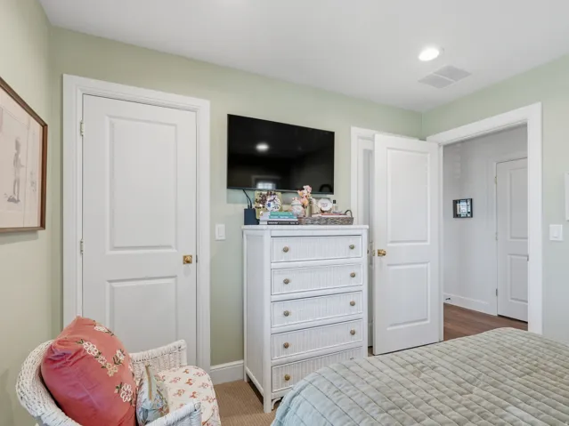 Recessed lighting, light-colored walls, white trim, and paneled doors