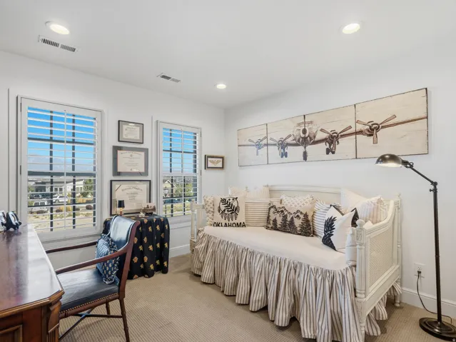 Recessed ceiling lighting, white plantation shutters, and light neutral wall paint