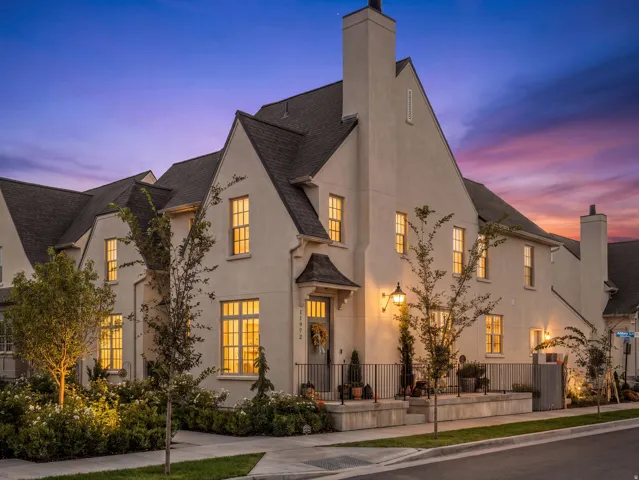 Stucco exterior with multiple gables and a dark shingle roof