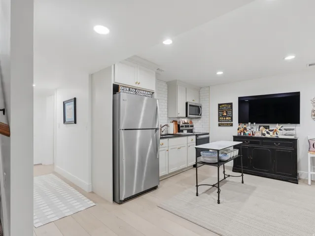 Kitchenette with white subway tile backsplash, stainless steel appliances, and recessed lighting
