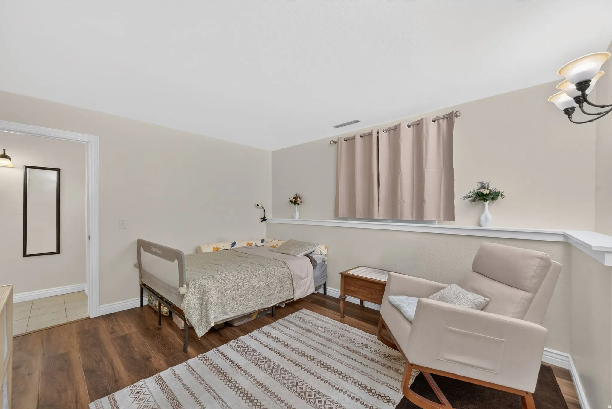 Master bedroom. Wood-finish flooring with neutral wall paint