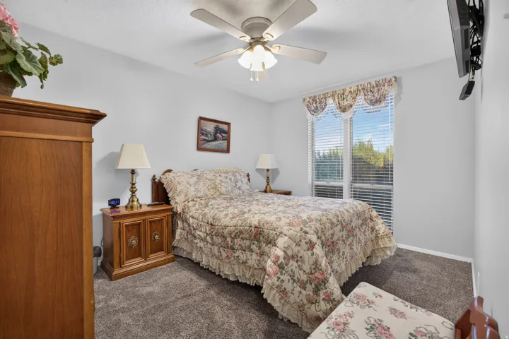 Primary bedroom with large, twin closets, and carpeted flooring.