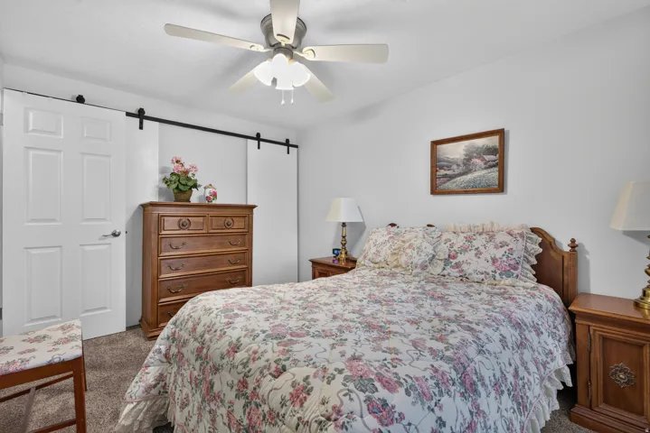 Primary bedroom with large, twin closets, and carpeted flooring.