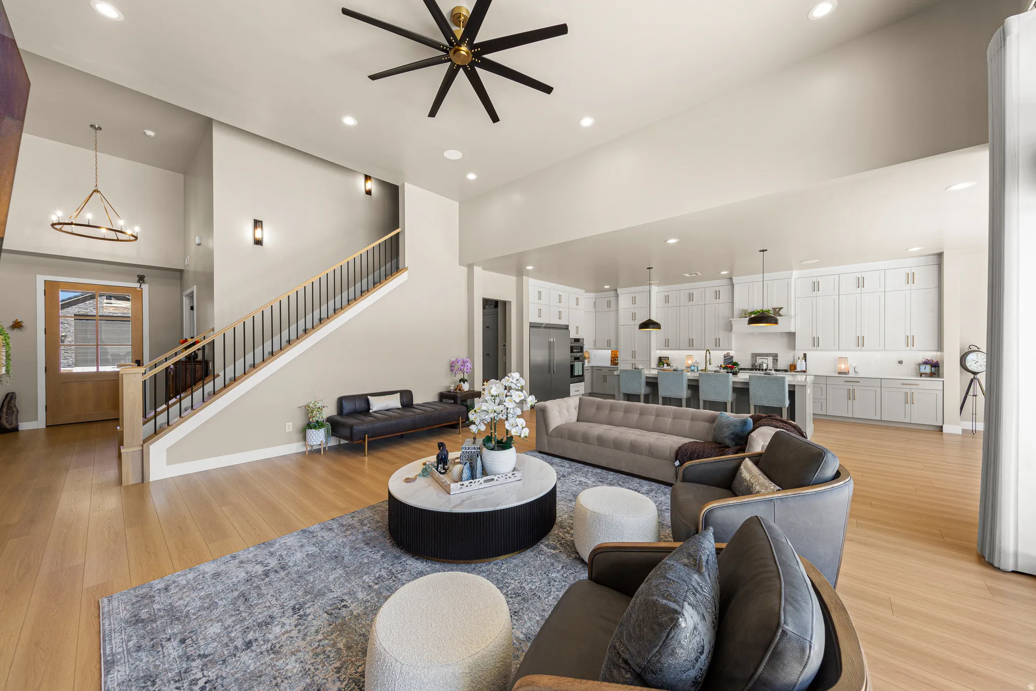 Open-concept living area with vaulted ceilings, recessed lighting, and wood-finish flooring