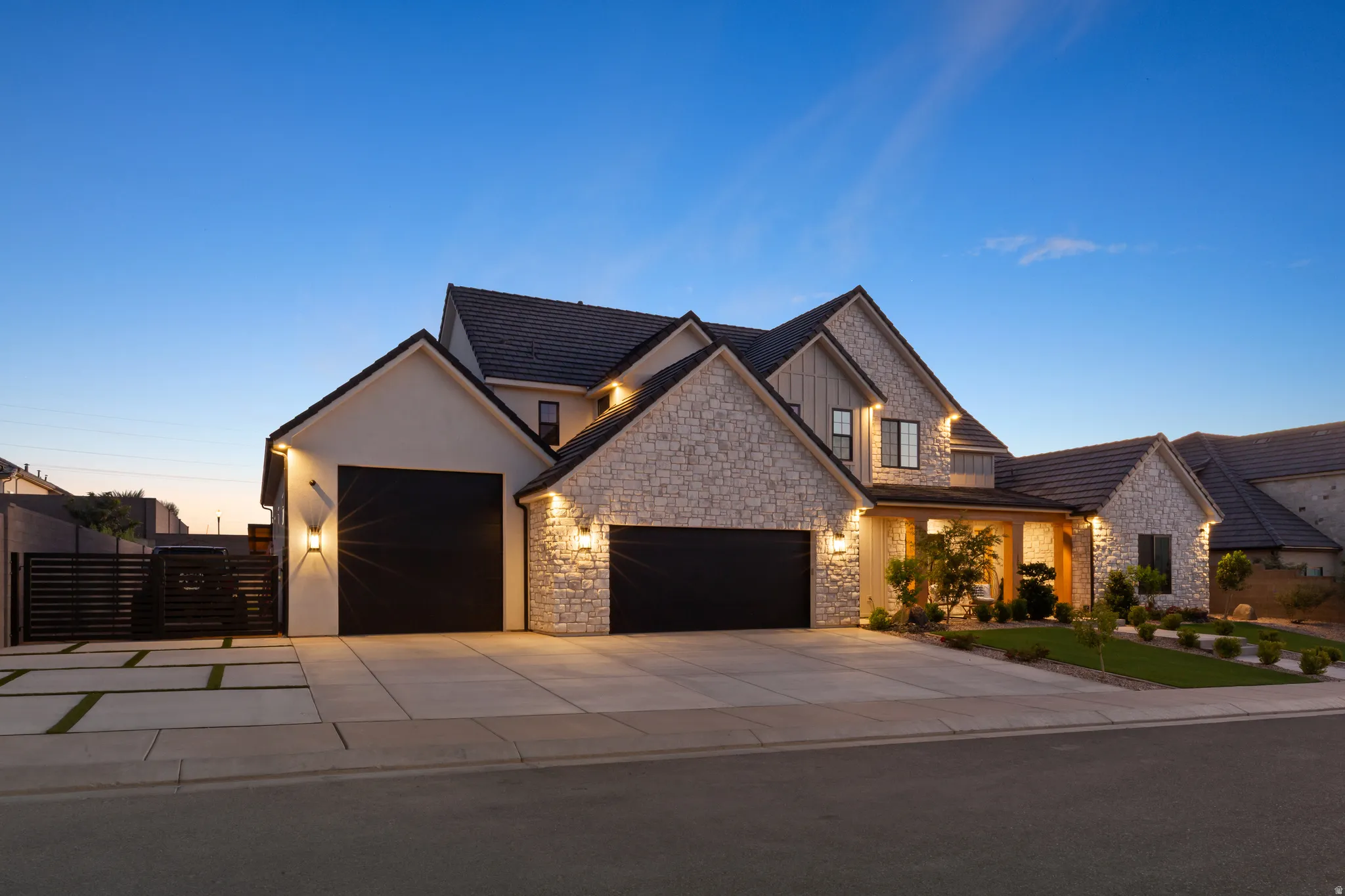 Stone and stucco exterior with dark-tiled roofing