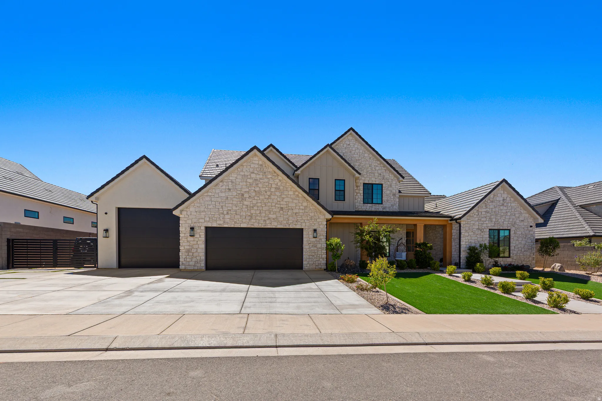 Stone veneer and board-and-batten exterior with an attached two-car garage