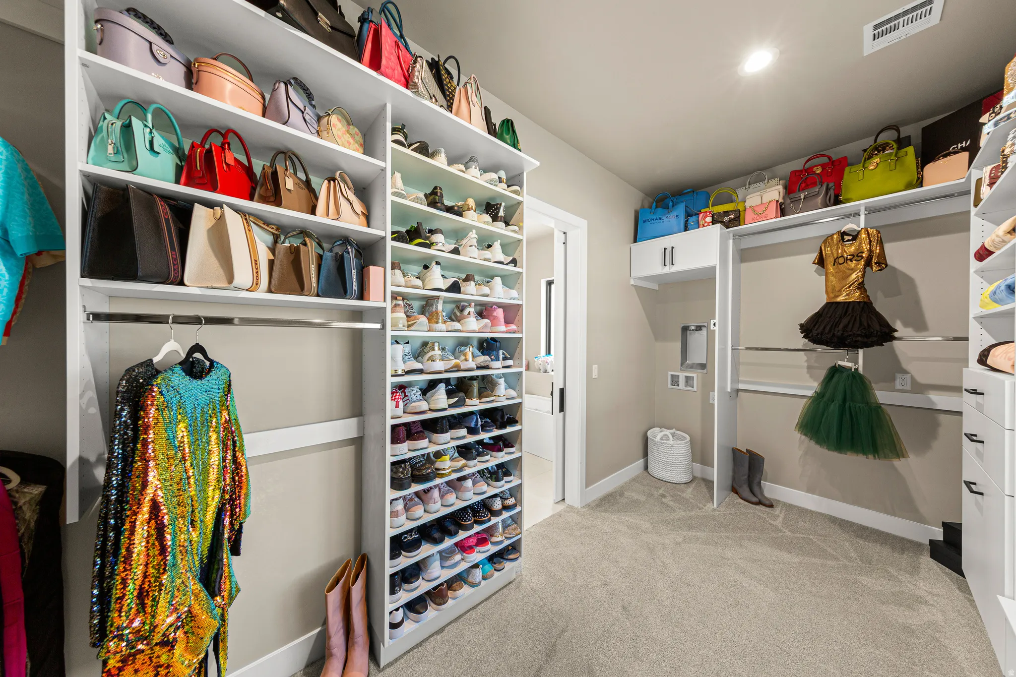 Custom closet system with extensive shelving, hanging rods, and built-in drawers