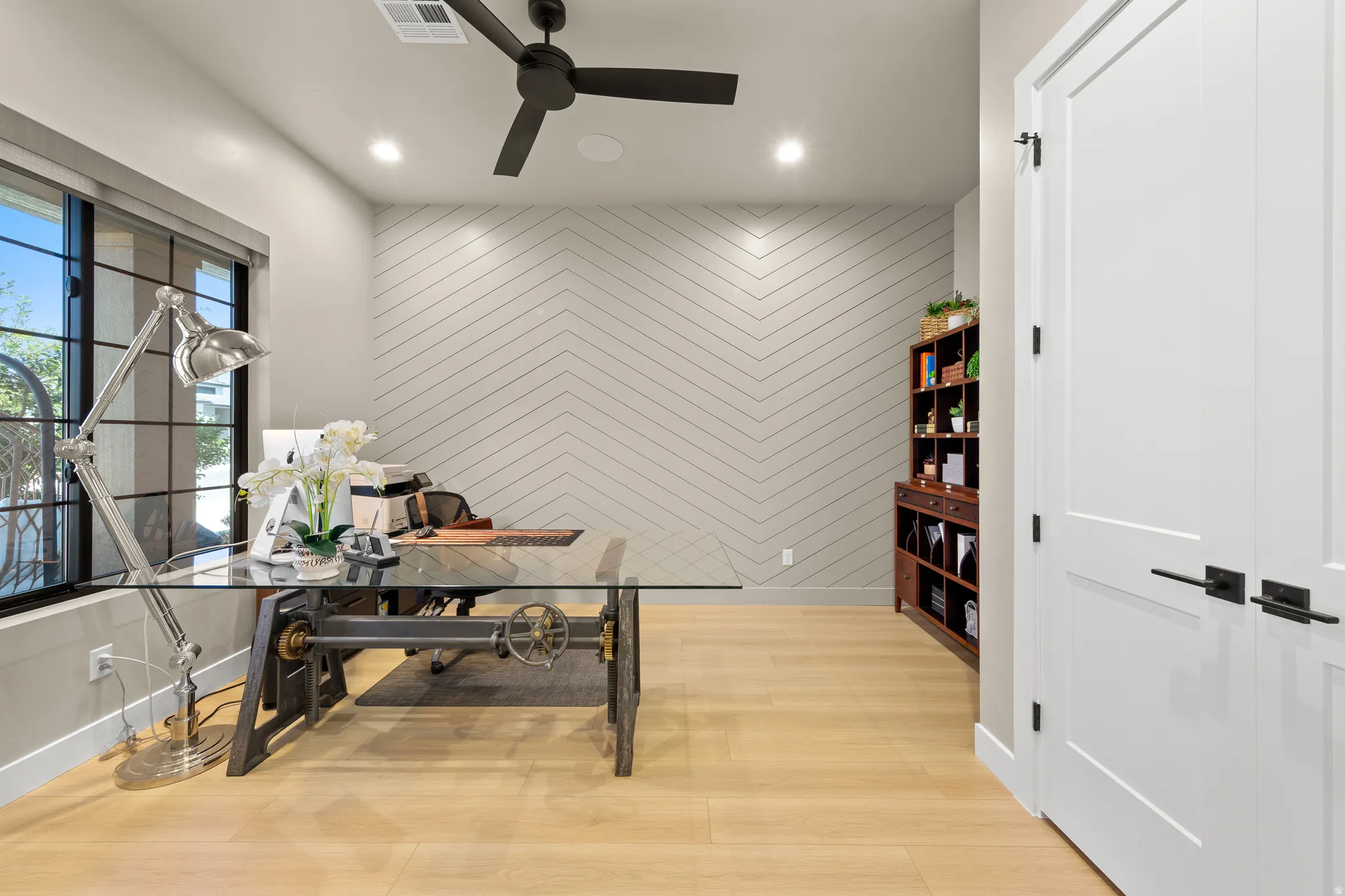 Light wood-finish flooring with a textured accent wall