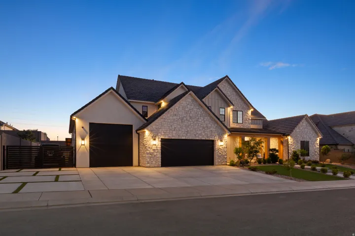 Stone and stucco exterior with dark-tiled roofing