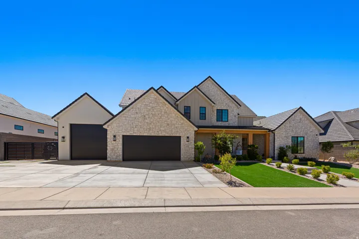 Stone veneer and board-and-batten exterior with an attached two-car garage