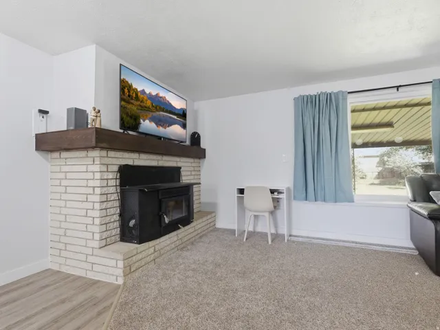 Brick hearth fireplace with a wood mantle