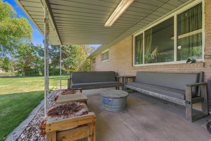 Covered patio with a concrete surface, and brick exterior wall