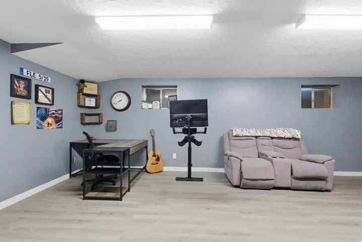 Recessed ceiling lighting, light gray wall paint, wood-finish flooring