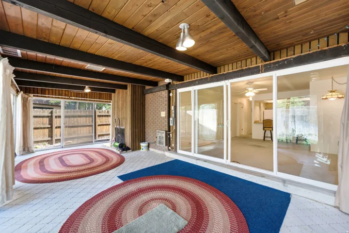 Exposed wood beam ceiling with natural wood paneling