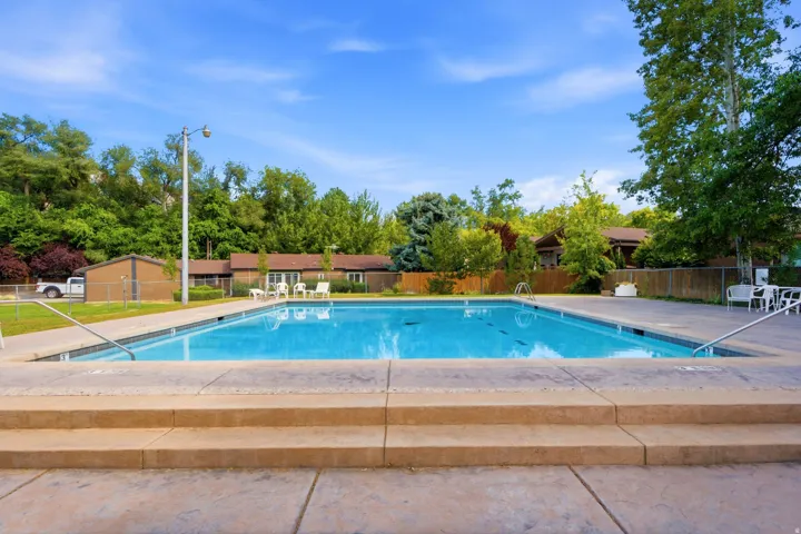 Outdoor swimming pool with concrete decking and integrated entry steps