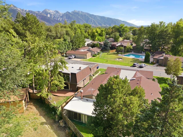 Mountain backdrop, mature trees, community pool, green spaces, residential structures