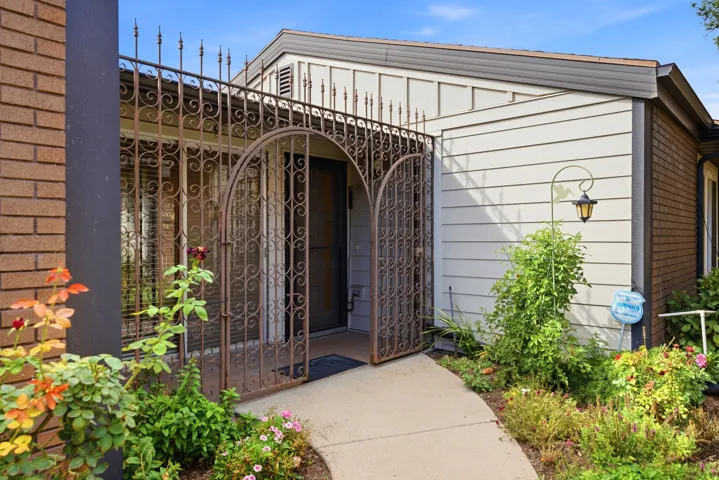 Wrought iron security gate with arched entry