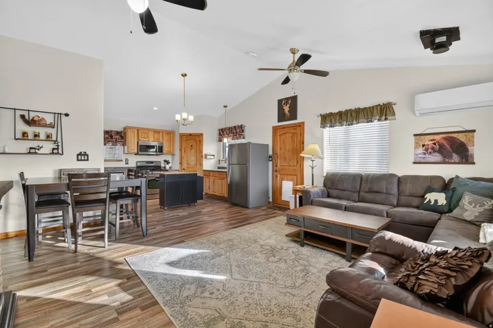 Vaulted ceiling, ceiling fans, wood-finish flooring, light wood-finish cabinetry, stainless steel appliances