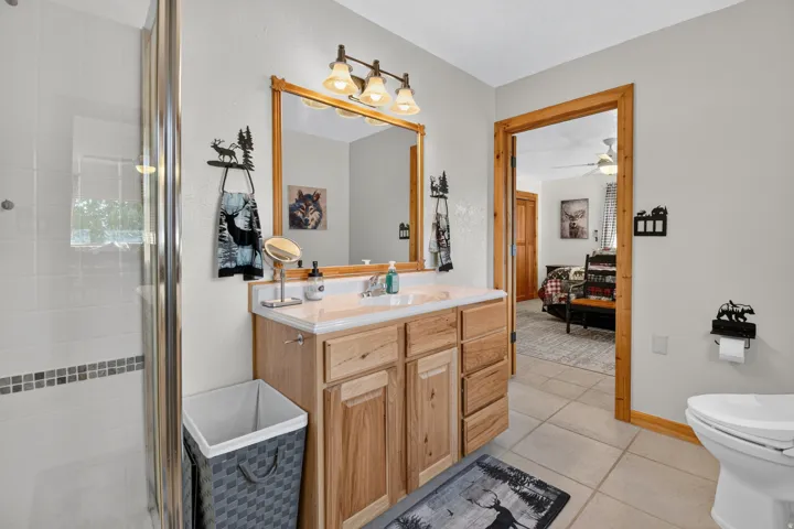 Primary en-suite with large walk-in shower and bidet toilet.