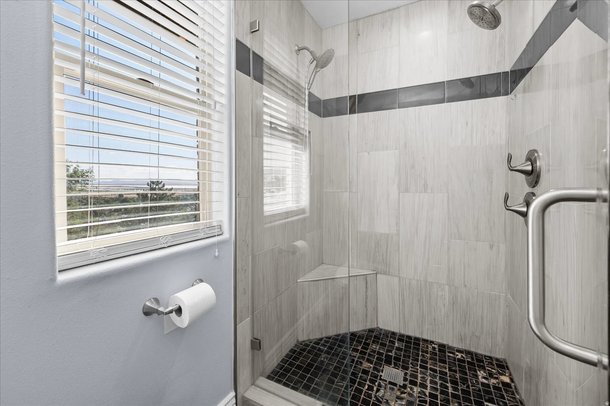 Primary Bathroom with updated marble shower and beautiful French glass door.