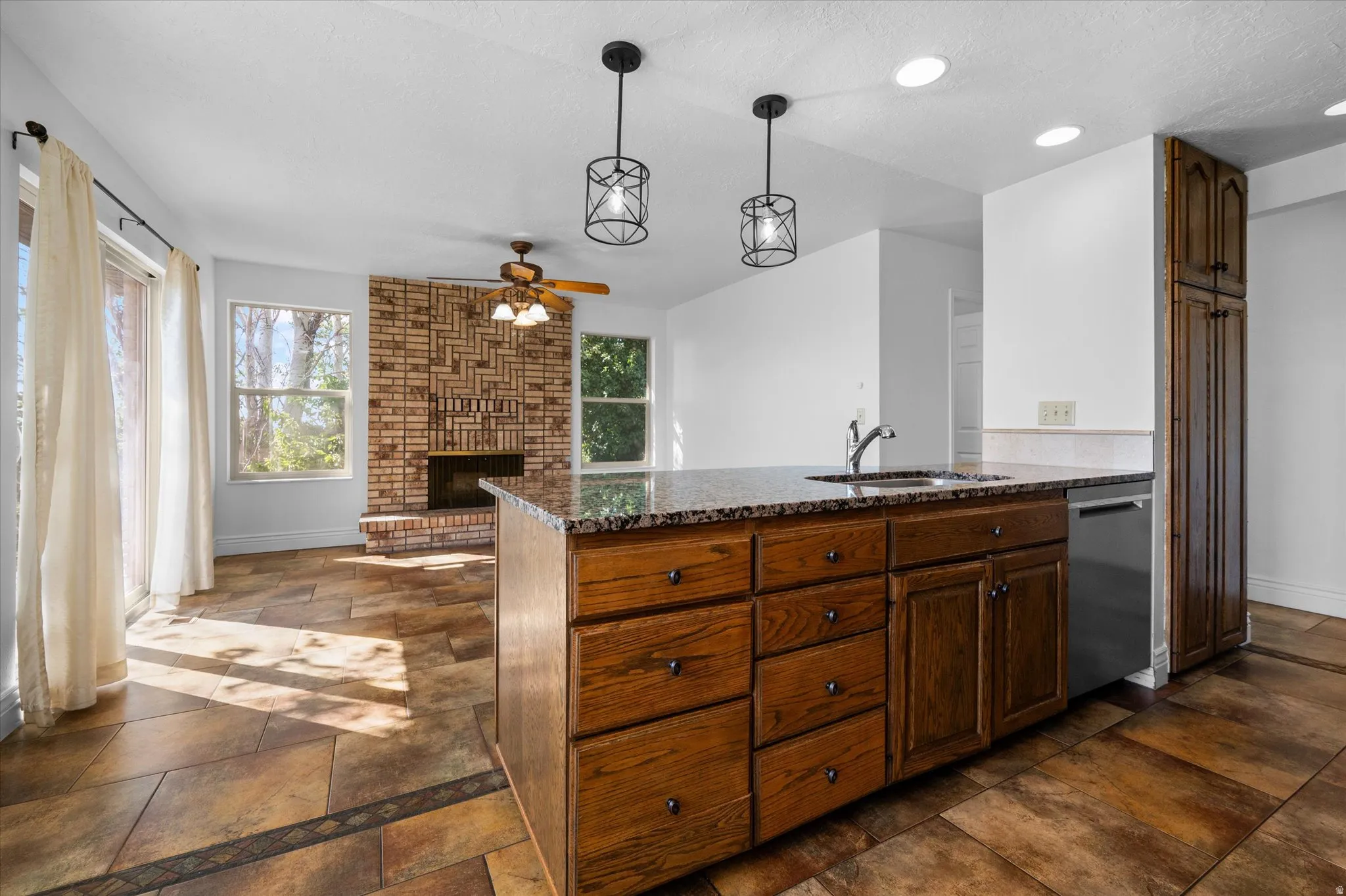 Kitchen w/breakfast nook and semi-formal dining and fireplace.