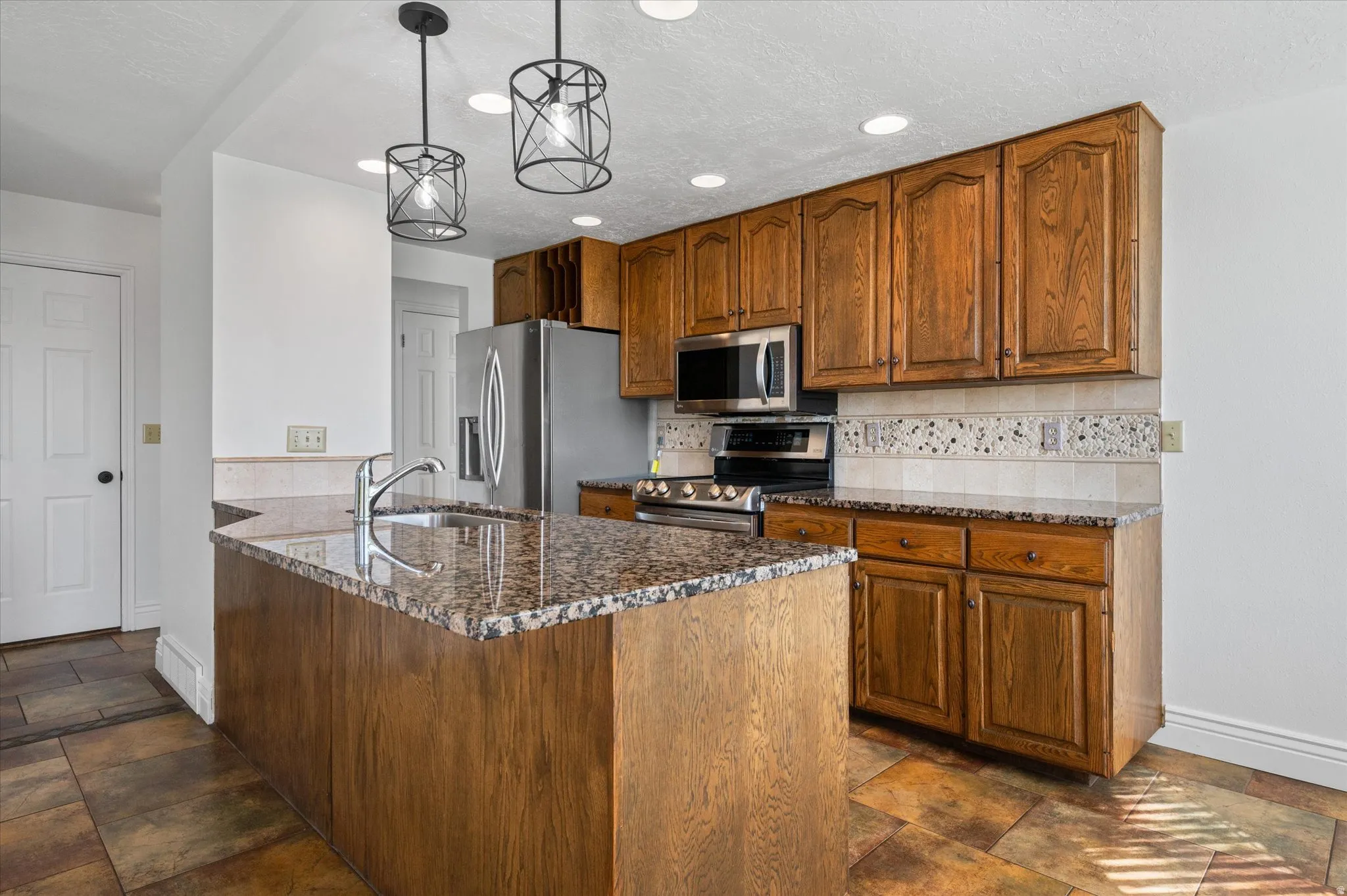 Kitchen w/breakfast nook and semi-formal dining and fireplace.