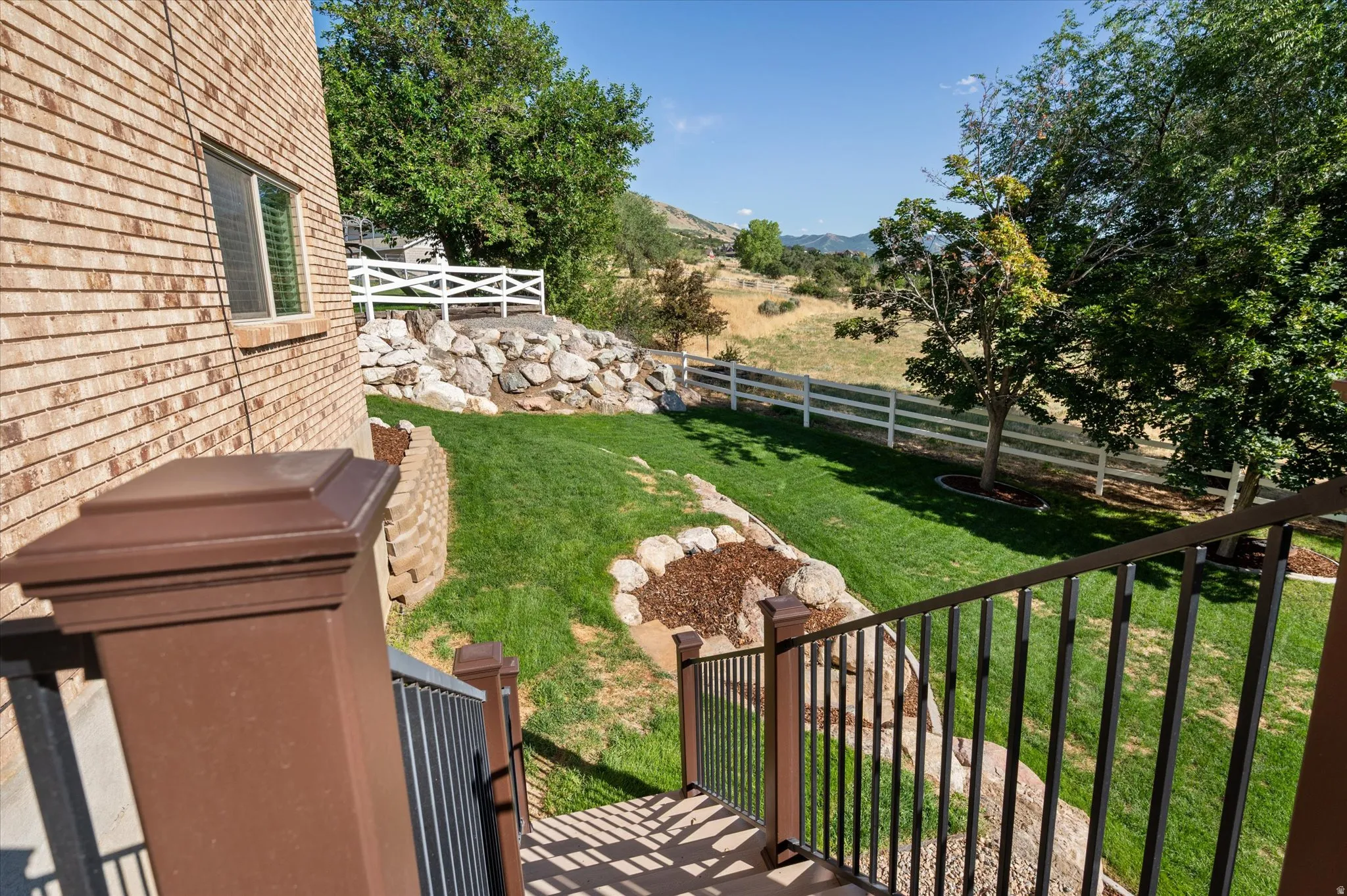 Deck stairs to immaculate yard!