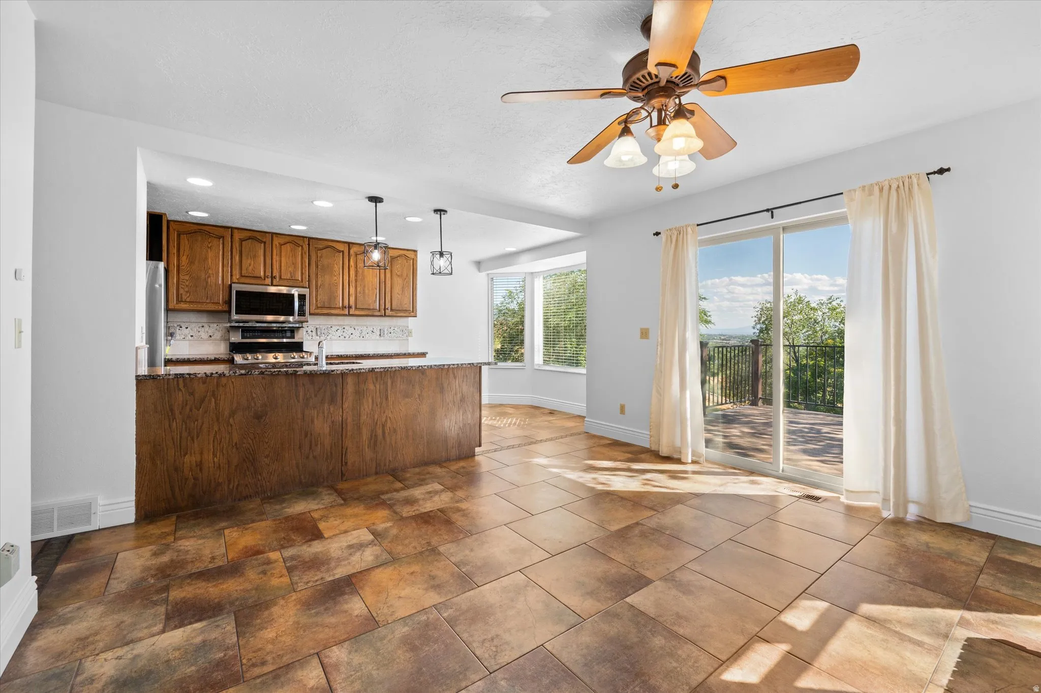 Kitchen w/breakfast nook and semi-formal dining and fireplace.